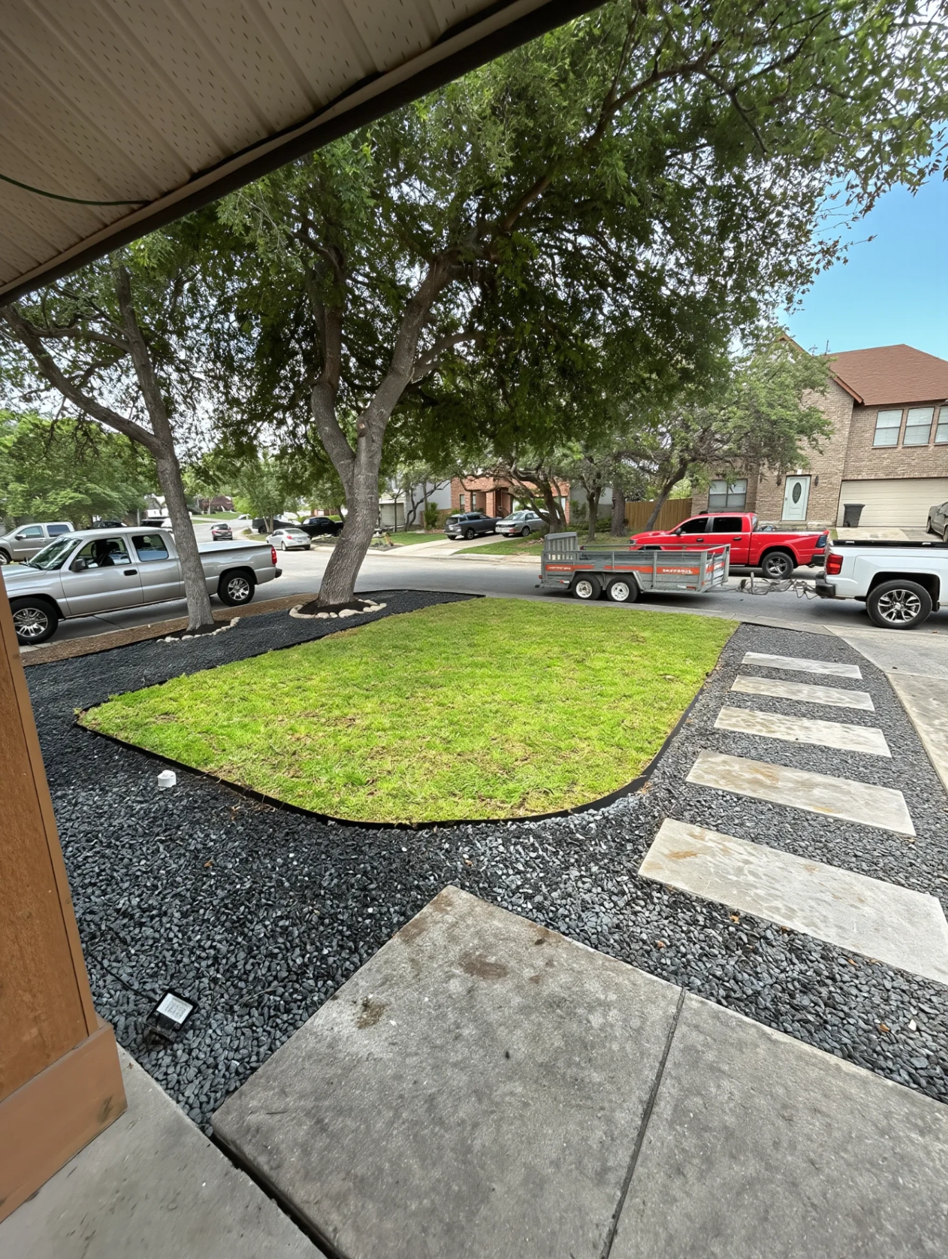 New paver walkway threading clipped boxwood beds