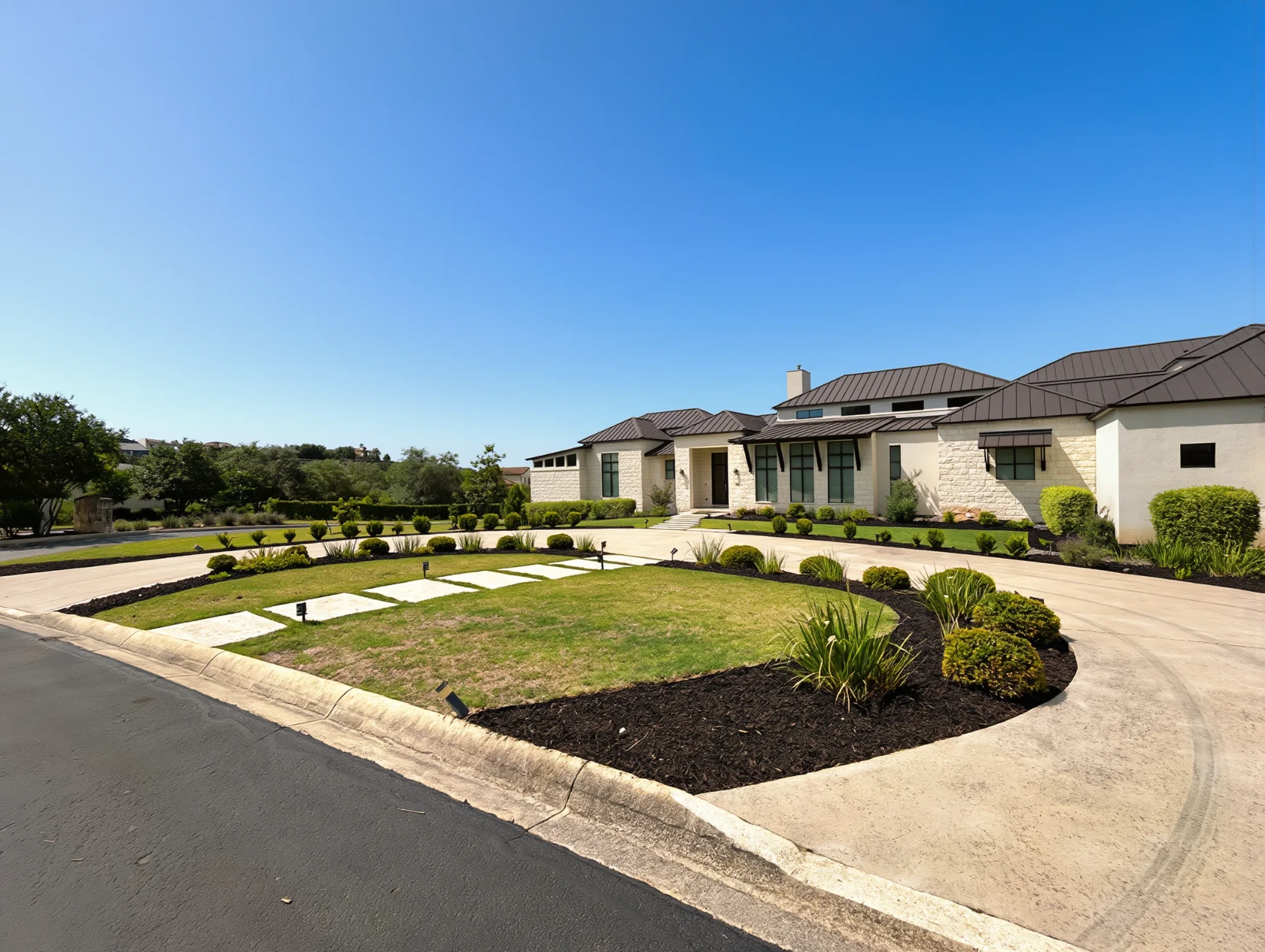 White ranch with circular front lawn framed by curved beds
