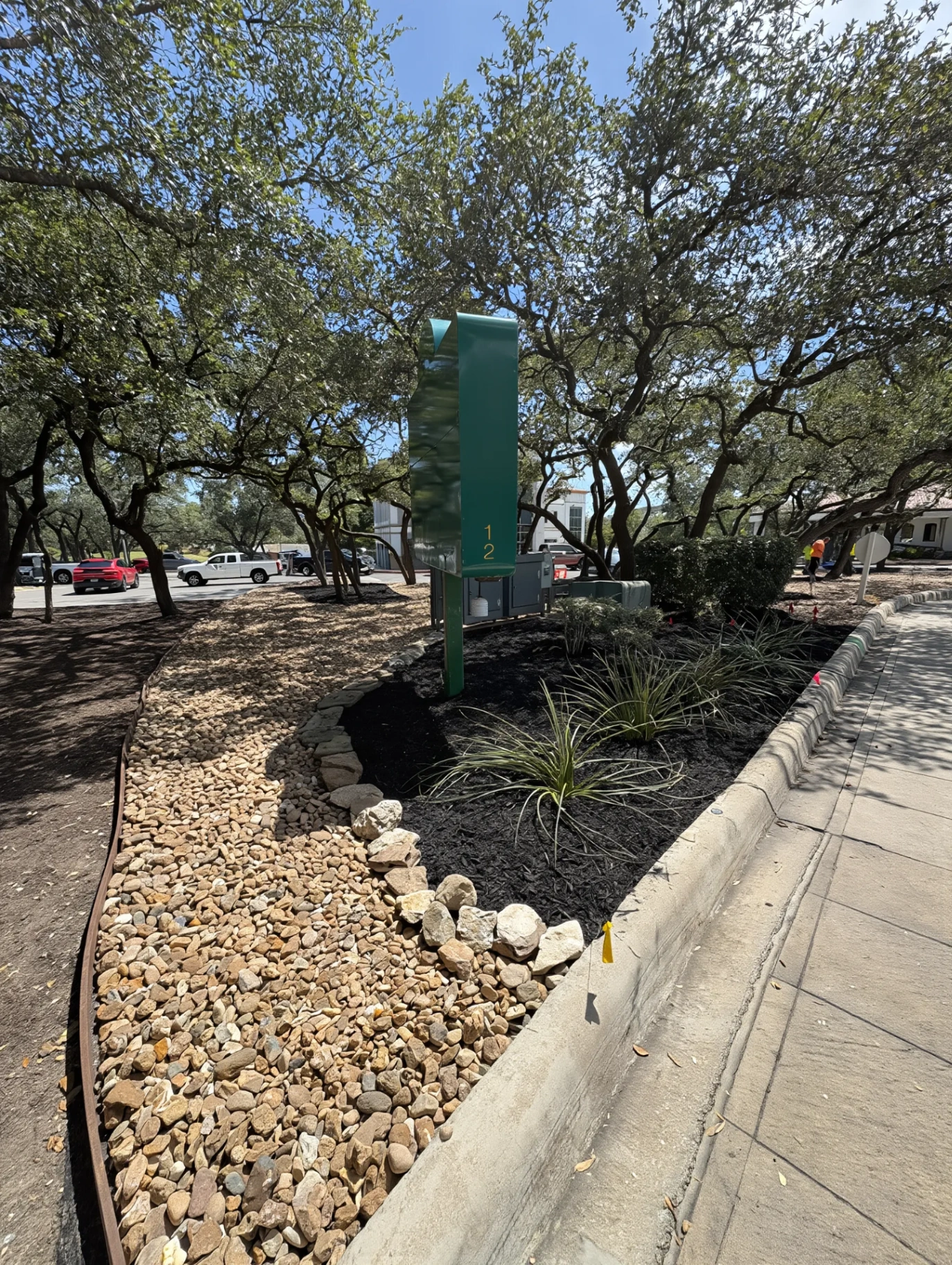 River-rock xeriscape strip along front curb
