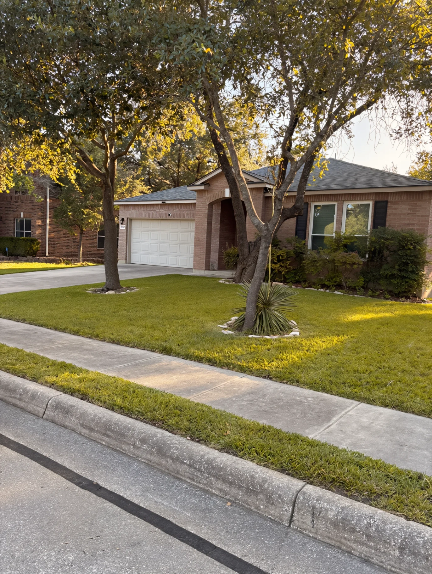 Brick home at golden hour with new paver walk